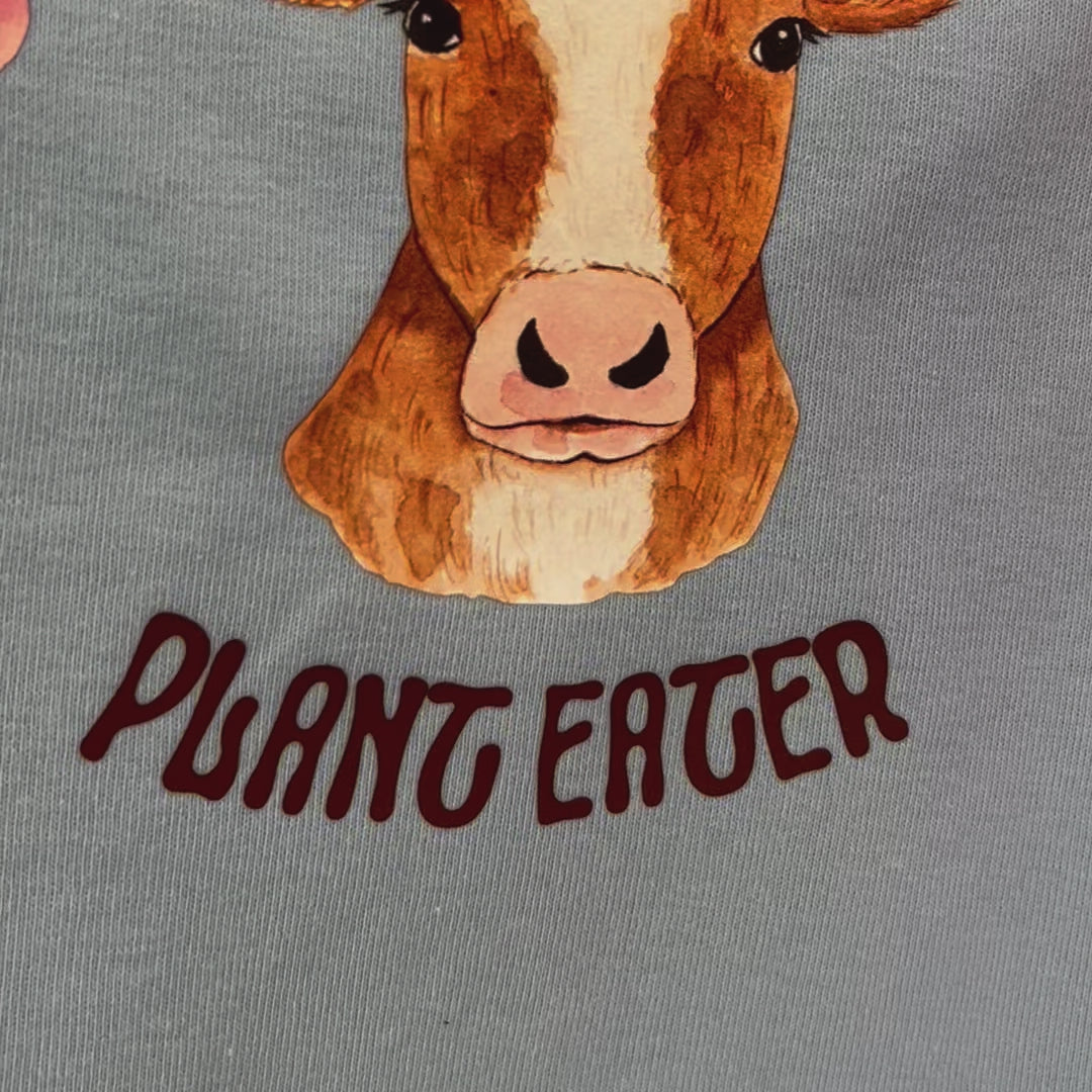 Cute pink and blue crop top featuring vegan activism graphic of a cow with flowers and text "animal lover plant eater"