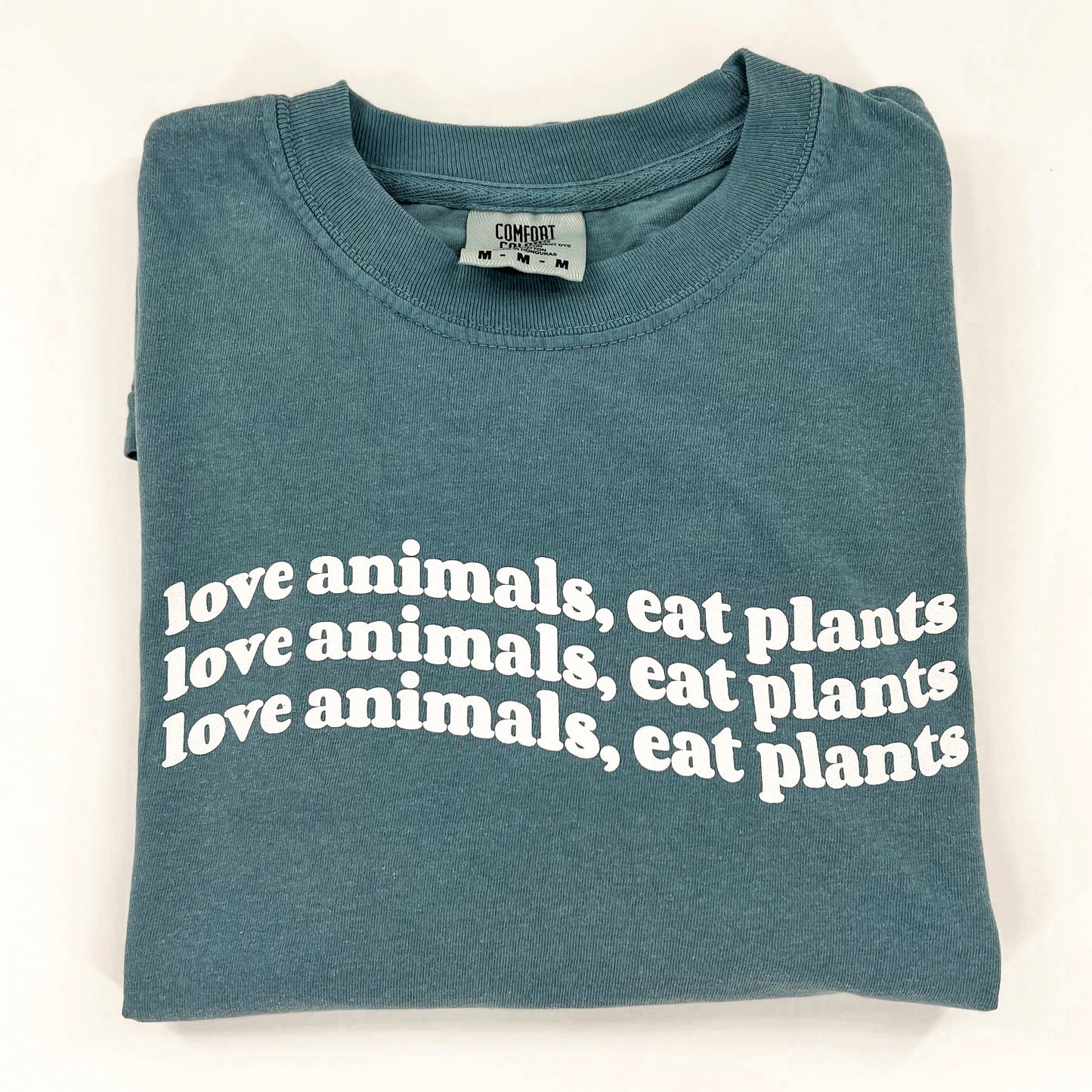 Love Animals Eat Plants vegan activism wavy design on blue short sleeve shirt Edit alt text