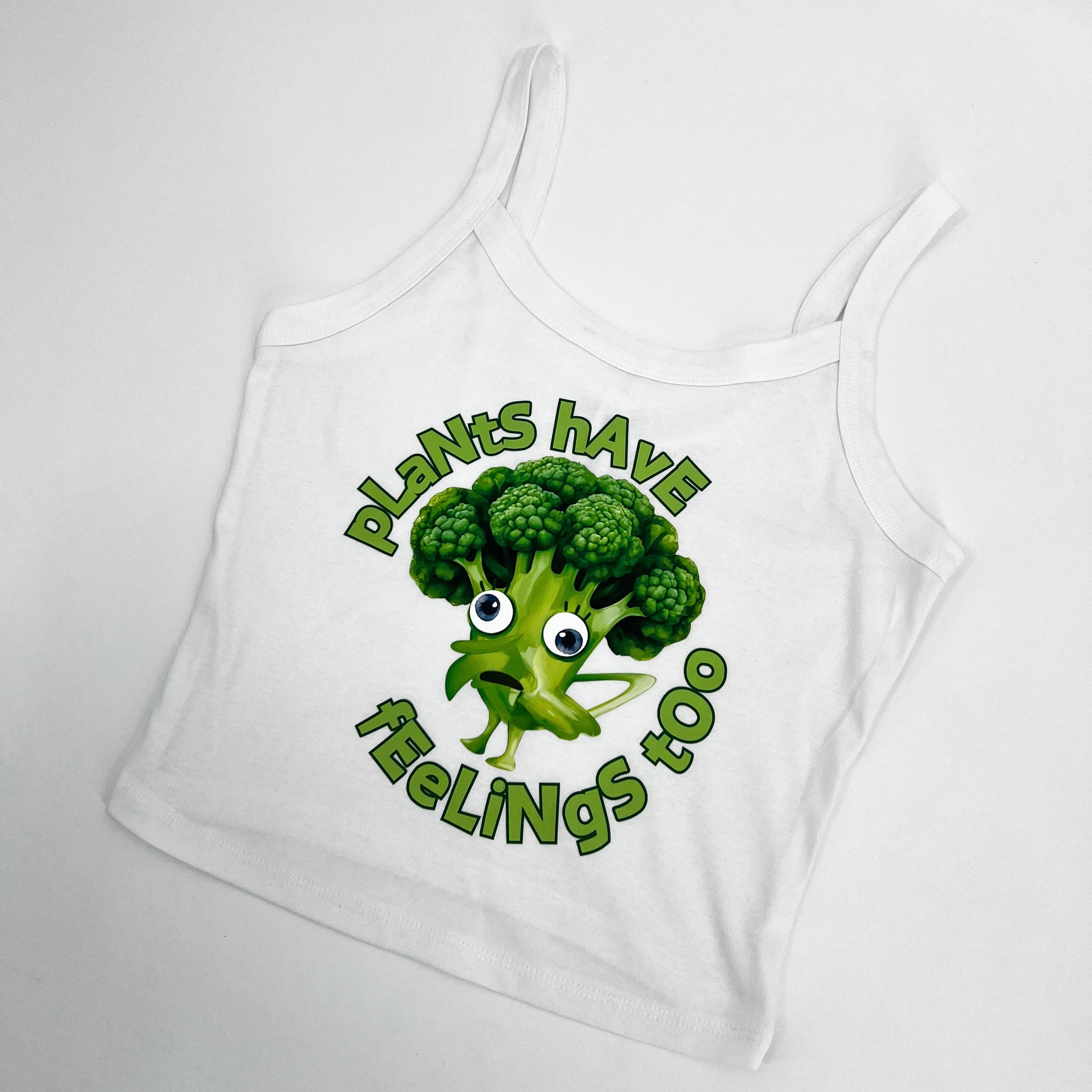 White cropped tank top featuring funny vegan activism graphic plants have feelings too