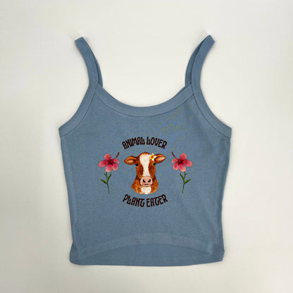 Cute pink and blue crop top featuring vegan activism graphic of a cow with flowers and text animal lover plant eater