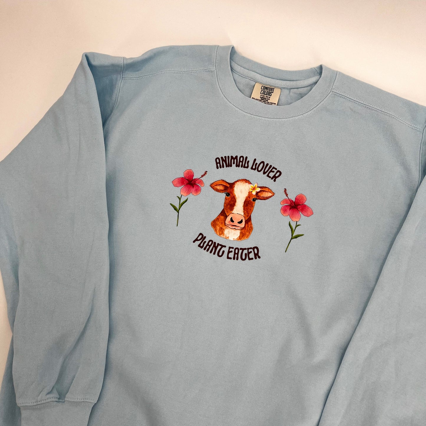 Light blue crewneck sweatshirt with vegan activism graphic Animal Lover Plant Eater