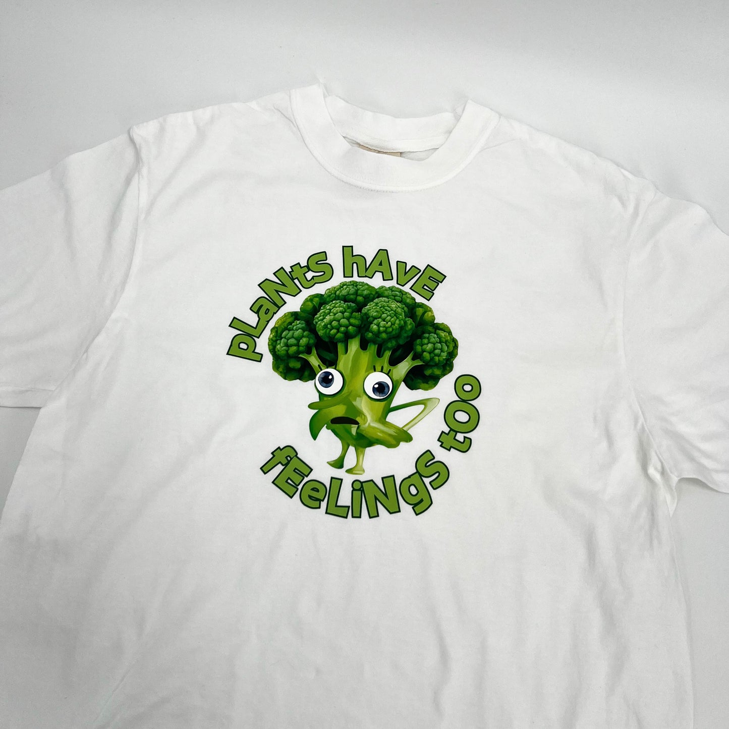 White vegan activism T-shirt featuring funny sarcastic Plants Have Feelings Too graphic