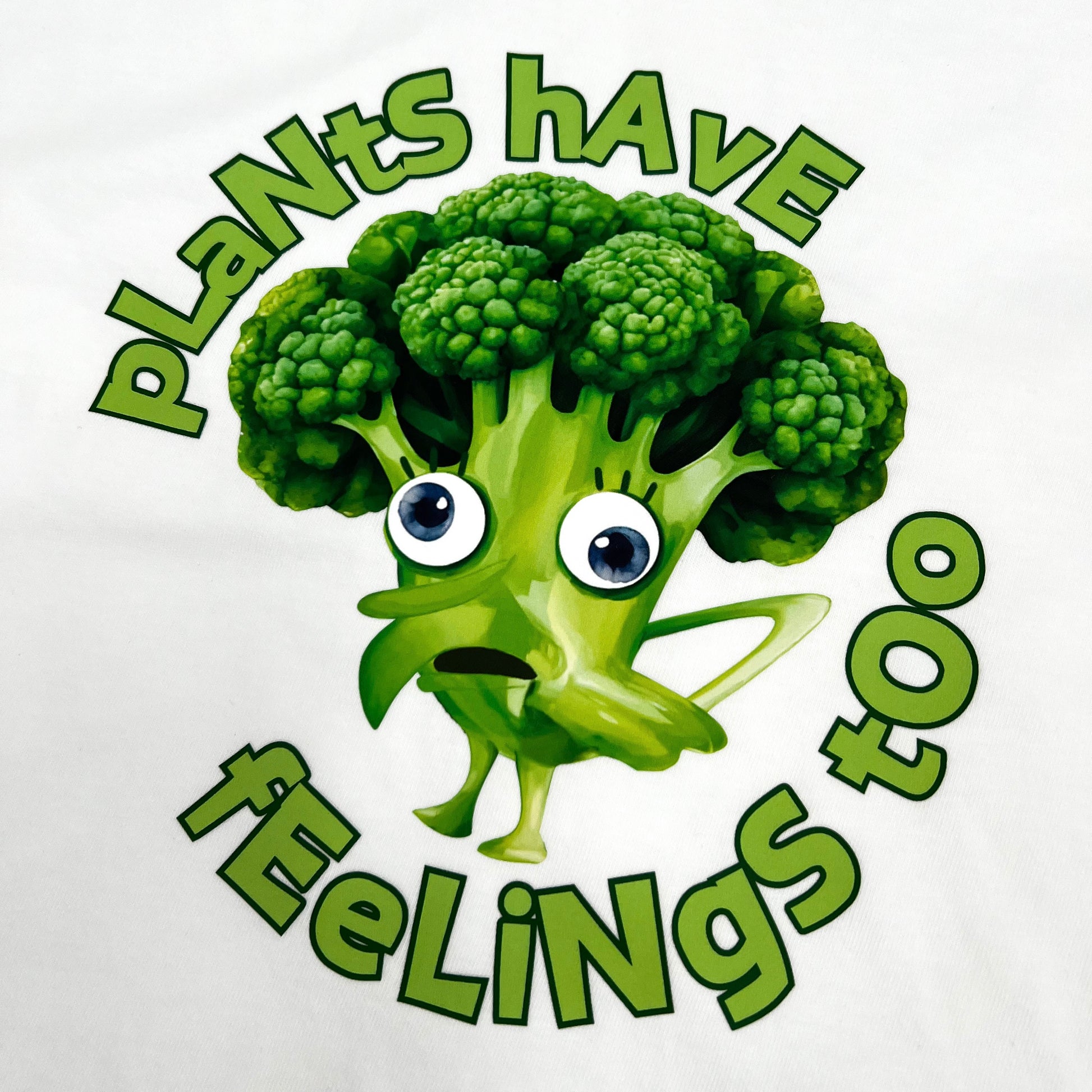 White vegan activism T-shirt featuring funny sarcastic Plants Have Feelings Too graphic