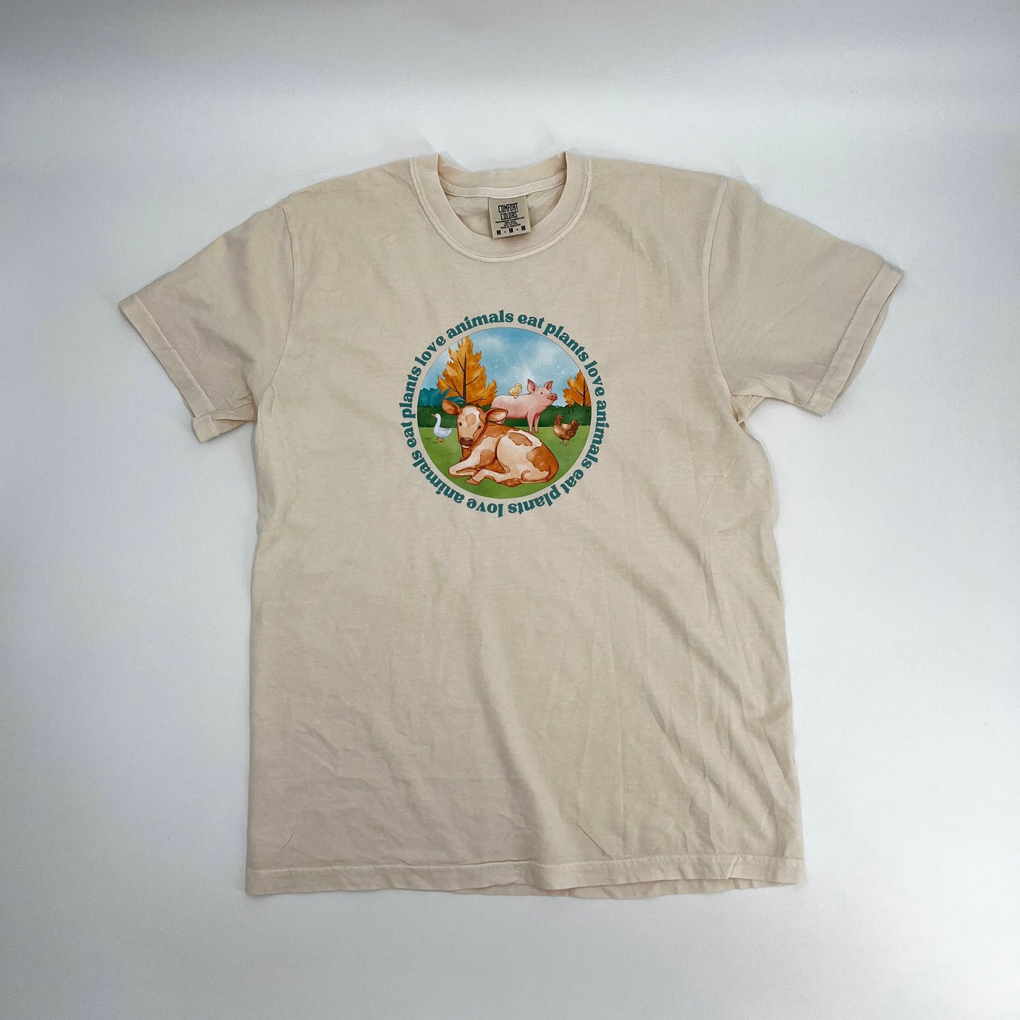 Natural colored vegan activism tee featuring farm animals graphic and text Love Animals Eat Plants