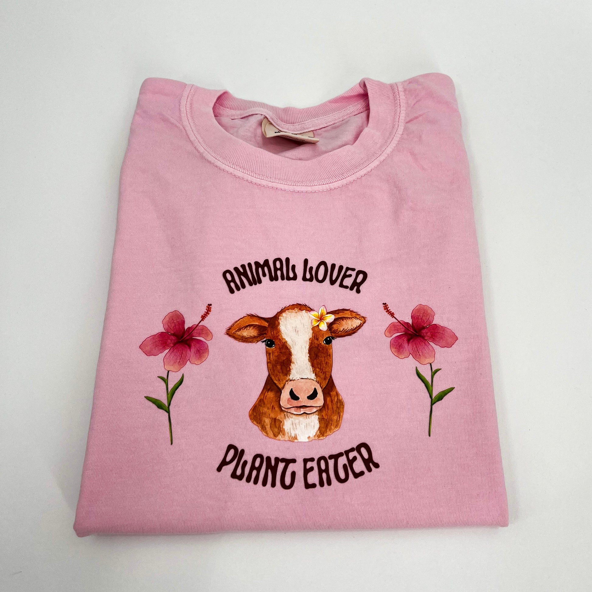 Pink T-shirt featuring vegan activism graphic Animal Lover Plant Eater