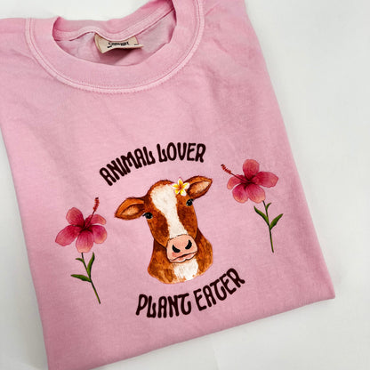 Pink T-shirt featuring vegan activism graphic Animal Lover Plant Eater