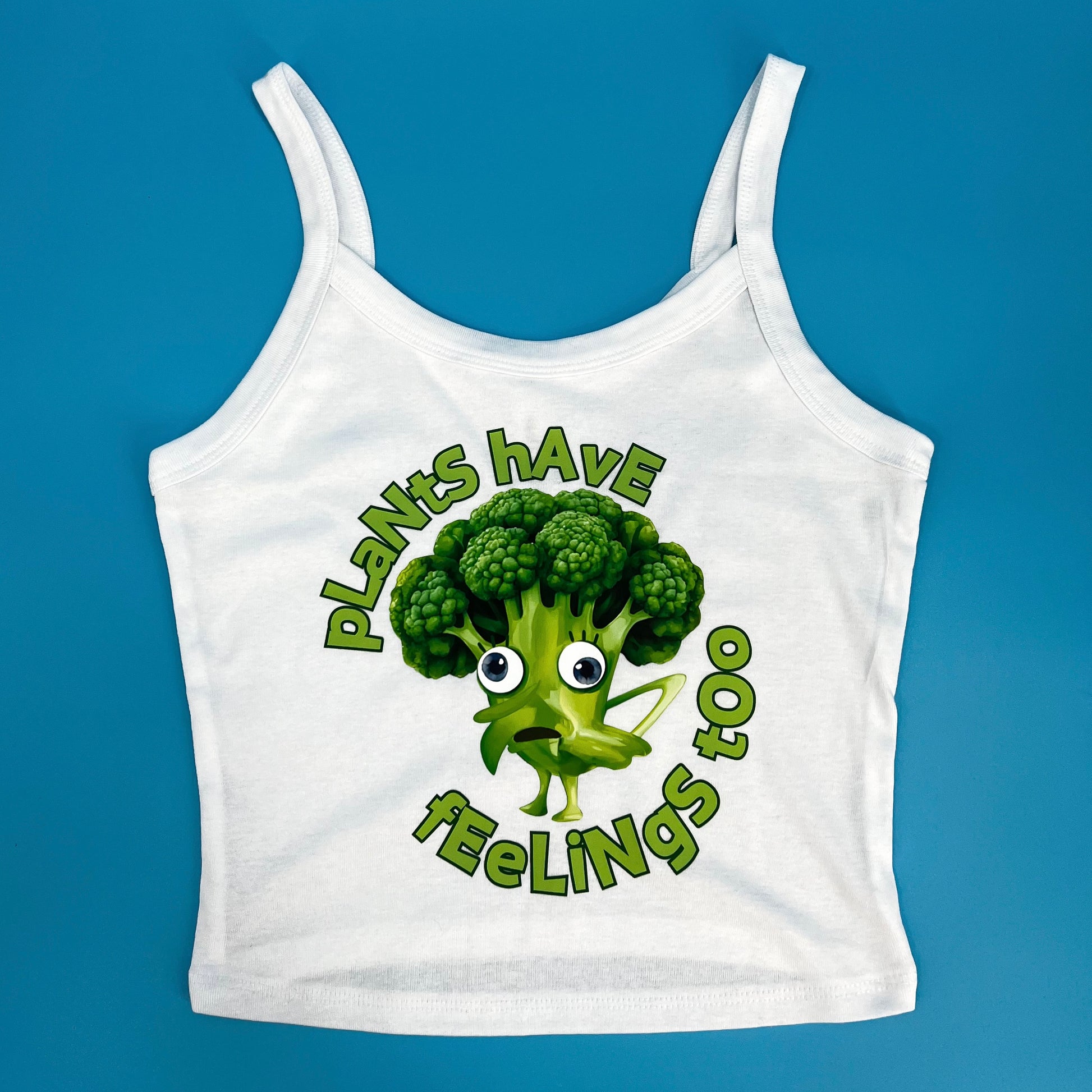 White cropped tank top featuring funny vegan activism graphic plants have feelings too