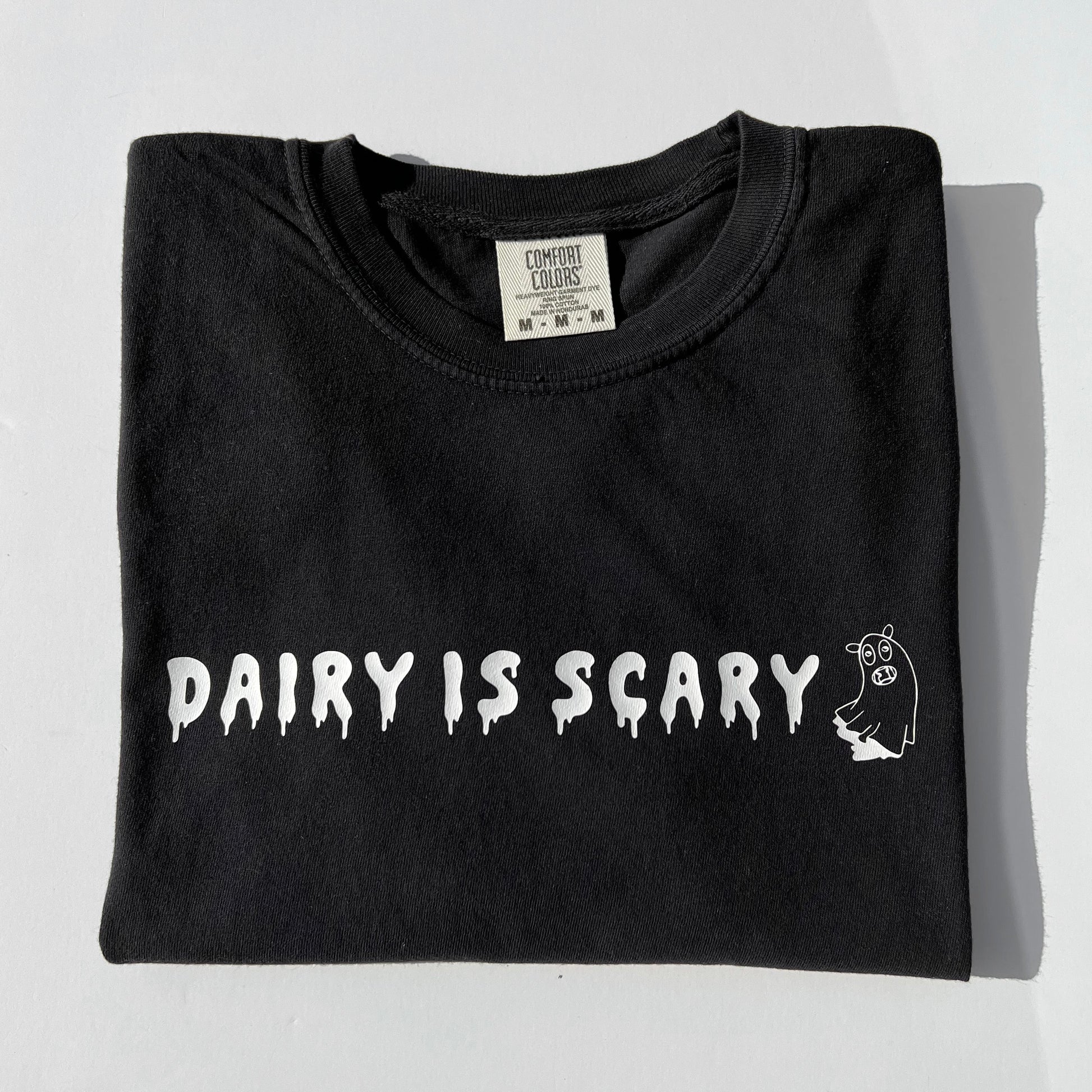 Black cotton t-shirt with Dairy Is Scary graphic design in white