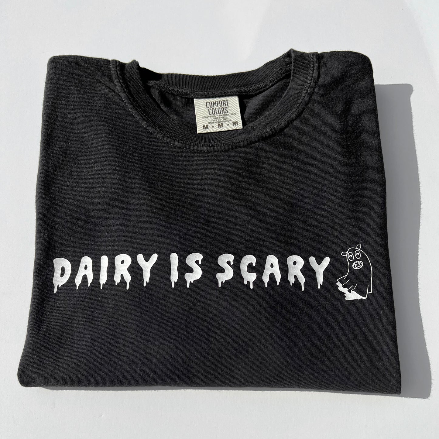 Black cotton t-shirt with Dairy Is Scary graphic design in white