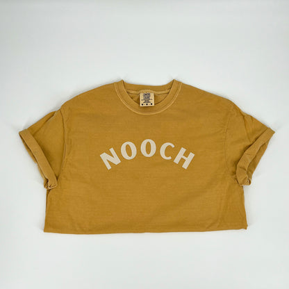 Mustard colored vegan activism t-shirt featuring "Nooch" graphic