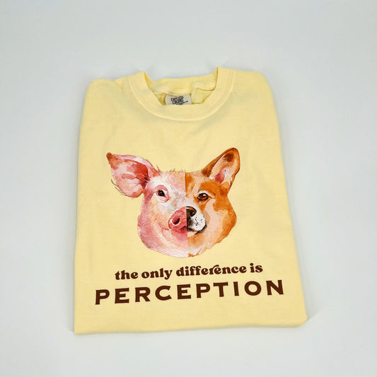 Yellow vegan activism t-shirt featuring "the only difference is perception" graphic