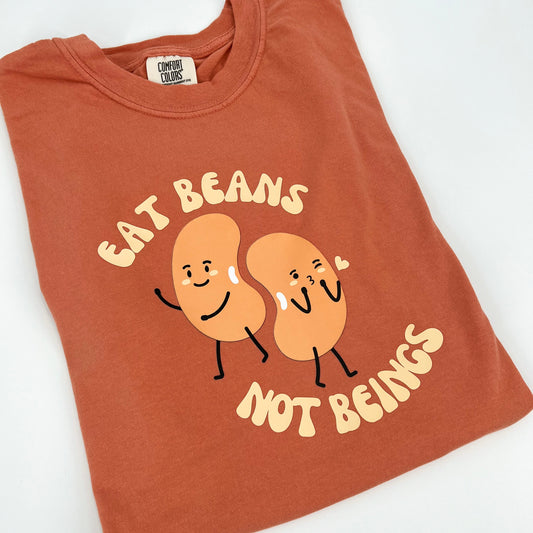 Terracotta colored vegan activism shirt featuring "Eat Beans Not Beings" graphic