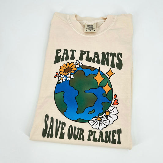 Ivory colored vegan activism t-shirt featuring "Eat Plants, Save Our Planet" graphic
