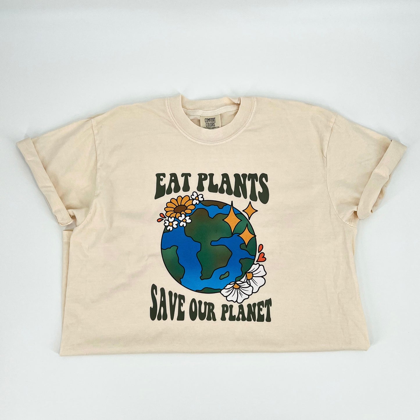 Ivory colored vegan activism t-shirt featuring "Eat Plants, Save Our Planet" graphic