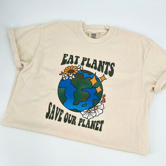 Ivory colored vegan activism t-shirt featuring "Eat Plants, Save Our Planet" graphic