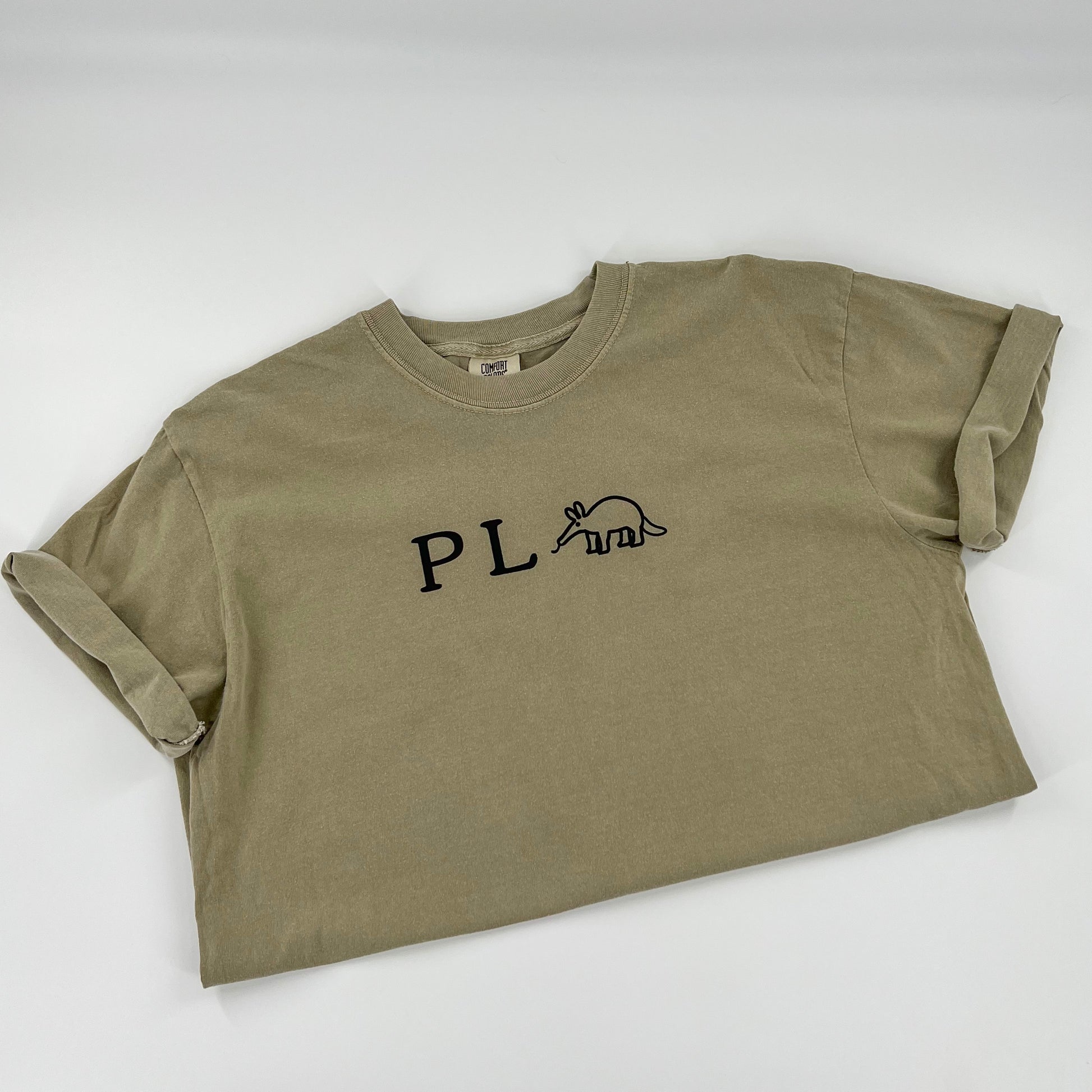 Punny P L Anteater vegan activism design in black on a khaki colored cotton shirt