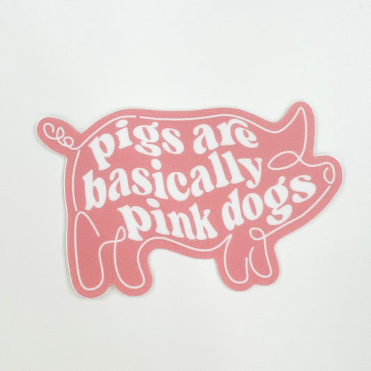 Pigs Are Basically Pink Dogs vegan activism sticker in pink with white text and pig outline